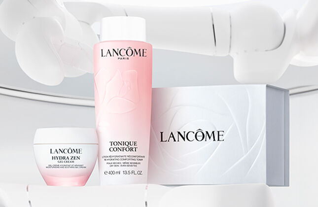 A well-lit display of Lancome skincare products, including a pink toner, a cream, and a box, all positioned on a sleek, white background.