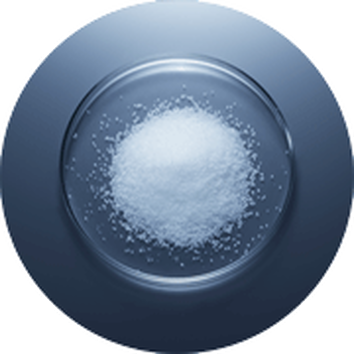 Bijeli kristalni šećer u staklenoj zdjeli na tamnoj pozadini.