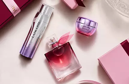 Lancome blagdanski poklon setovi u ružičastim kutijama vintage stila na pozadini snježnih planina.