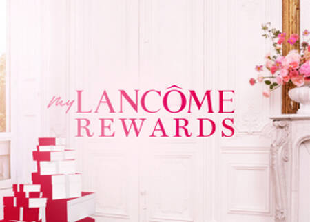 A bright, elegantly decorated room featuring a floral arrangement with pink flowers, alongside the text "My Lancome Rewards" in bold pink letters.